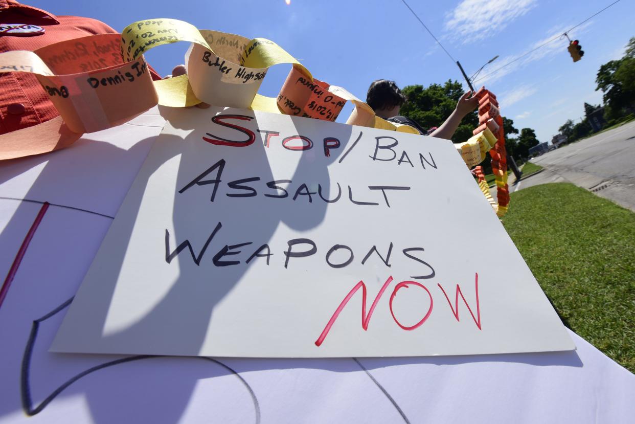 An activist holds a sign reading, "stop/ban assault weapons now" to protest gun violence during a rally on Saturday, June 11, 2022, at Pine Grove Park in Port Huron. The St. Clair County Democrats planning a rally this Saturday over issues related to the U.S. Supreme Court.