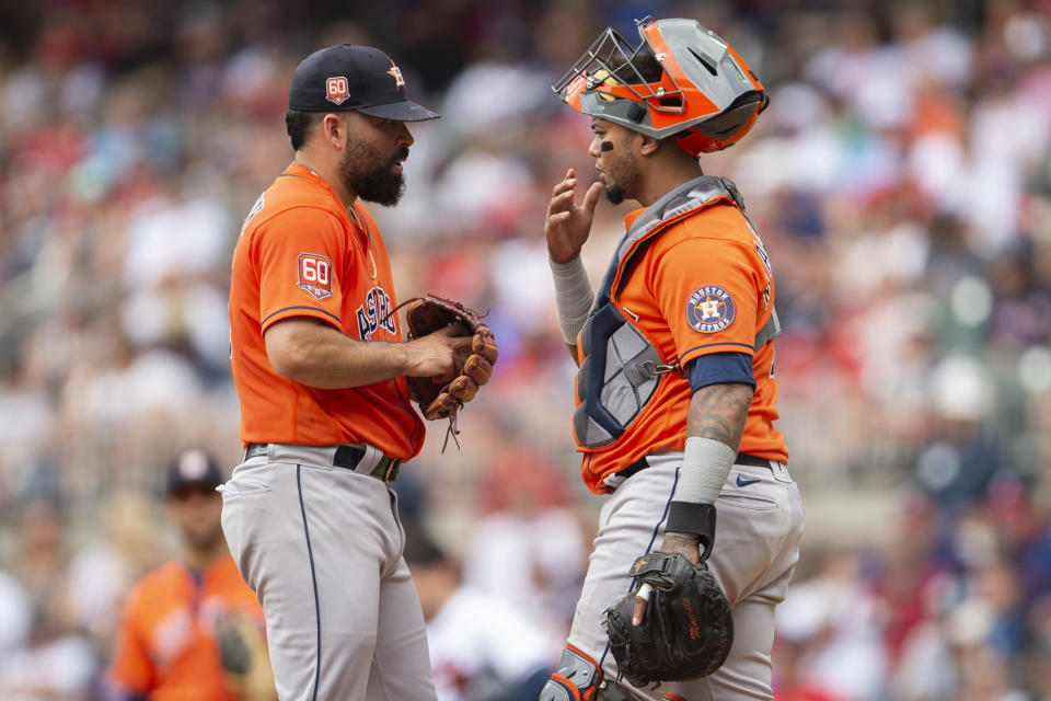 Houston Astros catcher Martin Maldonado, right, speaks with starting pitcher Jose Urquidy, left, in the first inning of a baseball game against the Atlanta Braves, Sunday, Aug. 21, 2022, in Atlanta. (AP Photo/Hakim Wright Sr.)