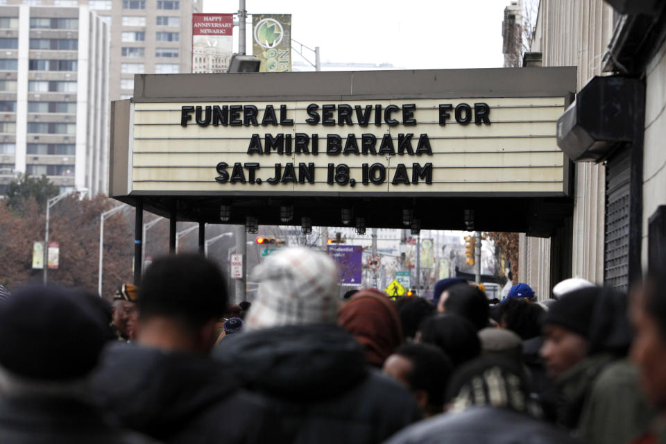 Mourners wait outside before entering the funeral of poet Amiri Baraka, Saturday, Jan. 18, 2014, in Newark, N.J. The 79-year-old author of blues-based poems, plays and criticism died Jan. 9 of an undisclosed illness. (AP Photo/Jason DeCrow)