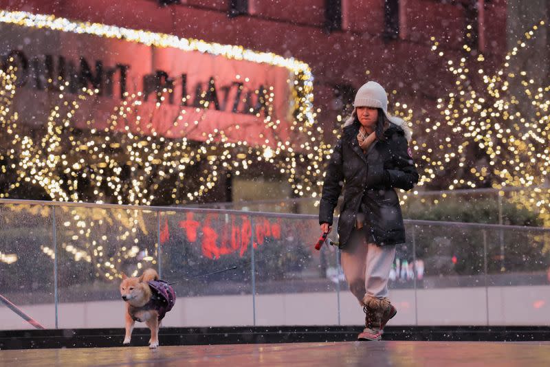 Snow falls in Times Square, in Manhattan