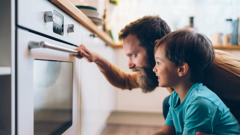 People looking into oven door