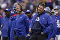 New York Giants head coach Joe Judge, right, and offensive coordinator Jason Garrett, left, react during the first half of an NFL football game against the Carolina Panthers, Sunday, Oct. 24, 2021, in East Rutherford, N.J. (AP Photo/Seth Wenig)