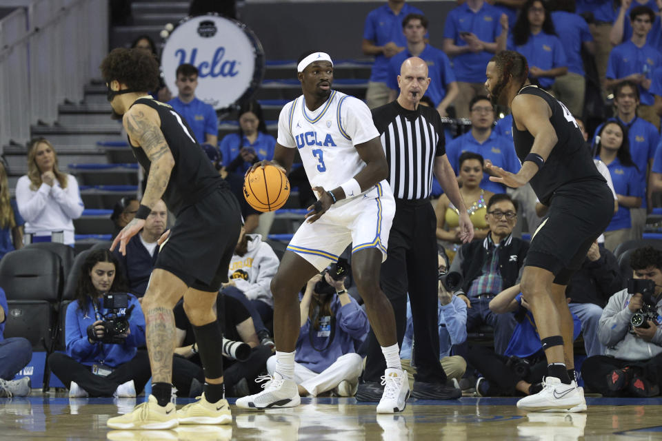 UCLA forward Adem Bona (3) dribbles while defended by Colorado center Eddie Lampkin Jr., right, during the first half of an NCAA college basketball game Thursday, Feb. 15, 2024, in Los Angeles. (AP Photo/Raul Romero Jr.)