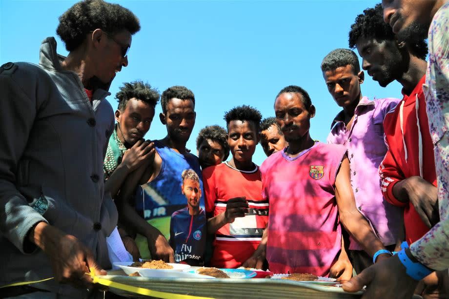 Ethiopians fleeing intense fighting in their homeland of Tigray, receive food in the neighbouring Sudanese Um Rakuba Refugee Camp, Gedaref State, Sudan. (EPA-EFE)