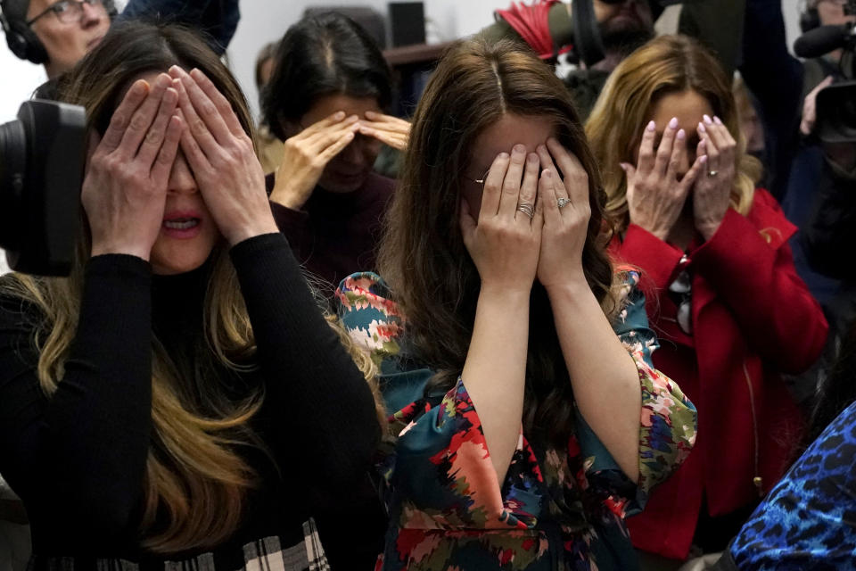 FILE - Members of the Chabad of Evanston, Ill., where Judith Raanan attended, cover their eyes as they pray at the beginning of Shabbat on Friday, Oct. 20, 2023, in Evanston. Raanan and her daughter Natalie were released Friday from their captivity in Gaza. (AP Photo/Charles Rex Arbogast, File)