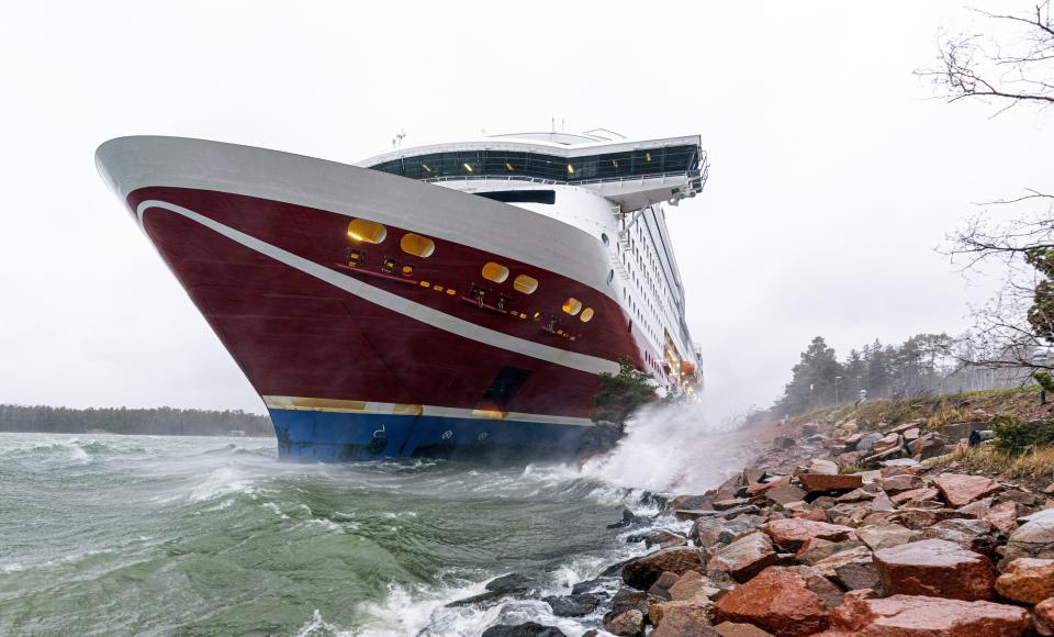 A view of the Viking Line cruise ship Viking Grace, run aground with passengers on board, south of Mariehamn, Finland, Saturday, Nov. 21, 2020. A Baltic Sea ferry with 331 passengers and a crew of 98 has run aground in the Aland Islands archipelago between Finland and Sweden. Finnish authorities say there are “no lives in immediate danger” and the vessel isn't leaking. The Finnish coast guard tweeted Saturday afternoon that the Viking Line ferry that runs between the Finnish port city of Turku and Swedish capital Stockholm hit ground just off the port of Mariehamn, the capital of the Aland Islands. (Niclas Nordlund/Lehtikuva via AP )