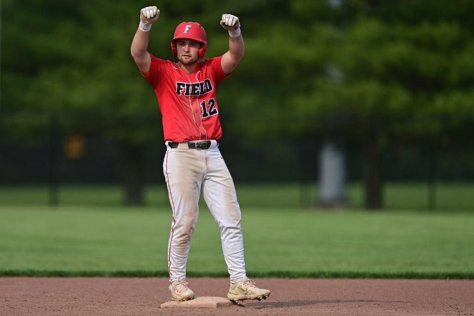 Field's Gavin Greene celebrates after hitting an RBI double in the fifth inning of their OHSAA tournament game against Ursuline Monday night at Cane Park in Struthers, Ohio.