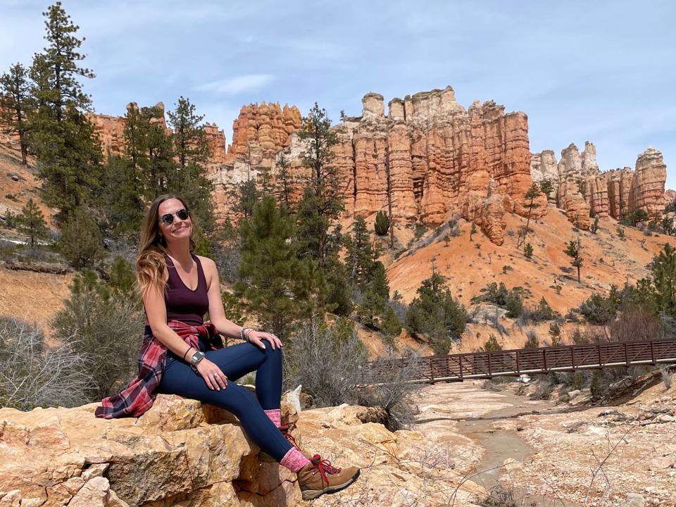 Emily sitting on a rock formation in Bryce Canyon National Park