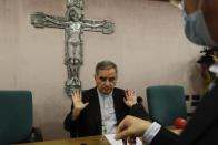 Cardinal Angelo Becciu talks to journalists during press conference in Rome, Friday, Sept. 25, 2020. The powerful head of the Vatican's saint-making office, Cardinal Angelo Becciu, has resigned from the post and renounced his rights as a cardinal amid a financial scandal that has reportedly implicated him indirectly. (AP Photo/Gregorio Borgia)