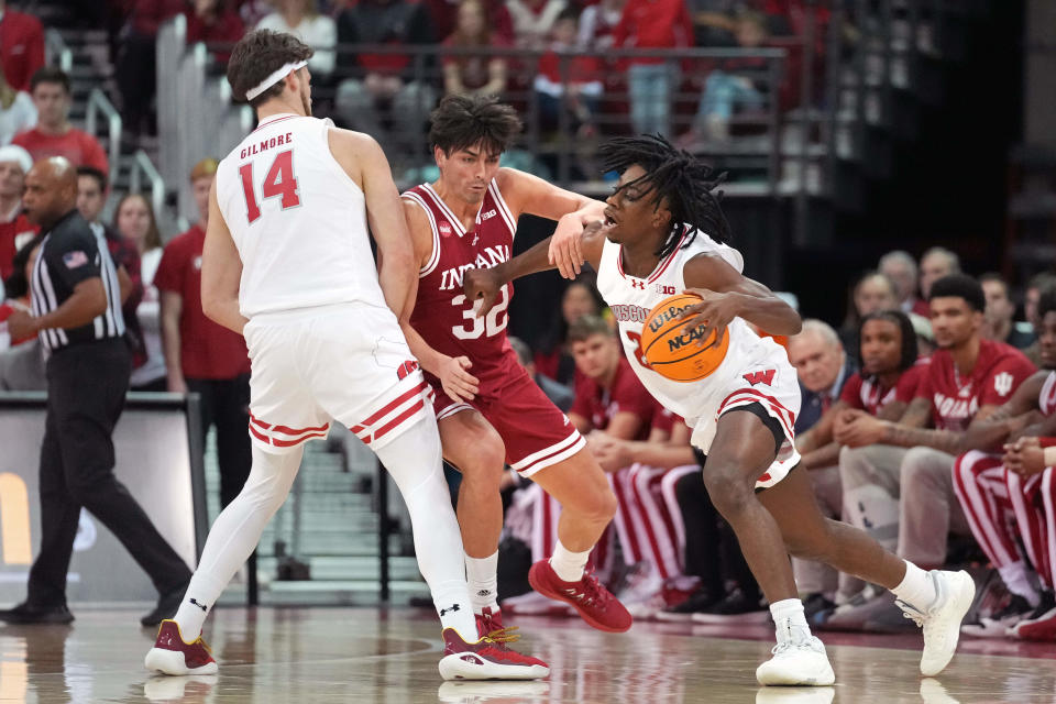 Jan 19, 2024; Madison, Wisconsin, USA; Wisconsin Badgers forward Carter Gilmore (14) sets a screen as Wisconsin Badgers guard John Blackwell (25) is fouled by Indiana Hoosiers guard Trey Galloway (32) during the first half at the Kohl Center. Mandatory Credit: Kayla Wolf-USA TODAY Sports