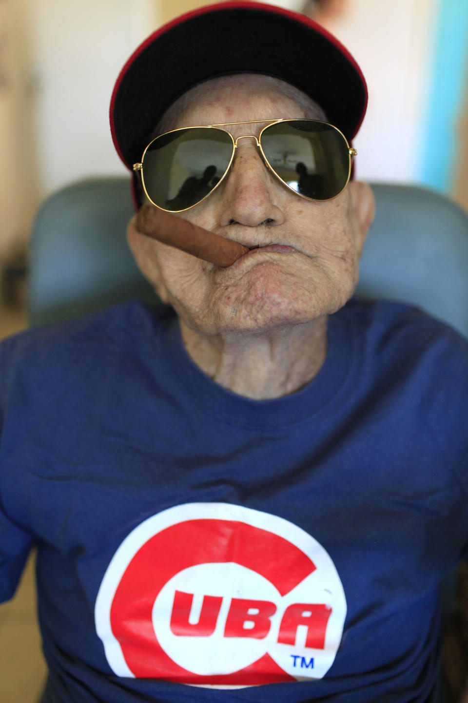 FILE - In this April 25, 2013 file photo, Conrado Marrero, the oldest living former Major League Baseball player, poses for a photo during his 102nd birthday bash at his home in Havana, Cuba. Family members say Conrado Marrero has died in Havana. He was 102, just two days short of his 103rd birthday. Grandson Rogelio Marrero confirmed the death Wednesday afternoon, April 23, 2014. (AP Photo/Franklin Reyes, File)