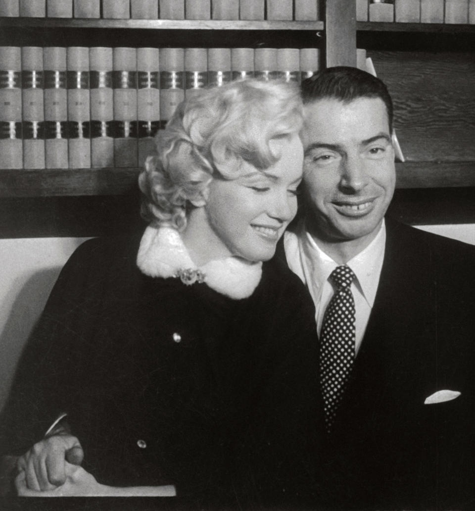 Marilyn Monroe and Joe DiMaggio Sitting Close Together (Bettmann Archive)