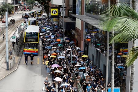 People carry umbrellas as they attend a protest in Hong Kong