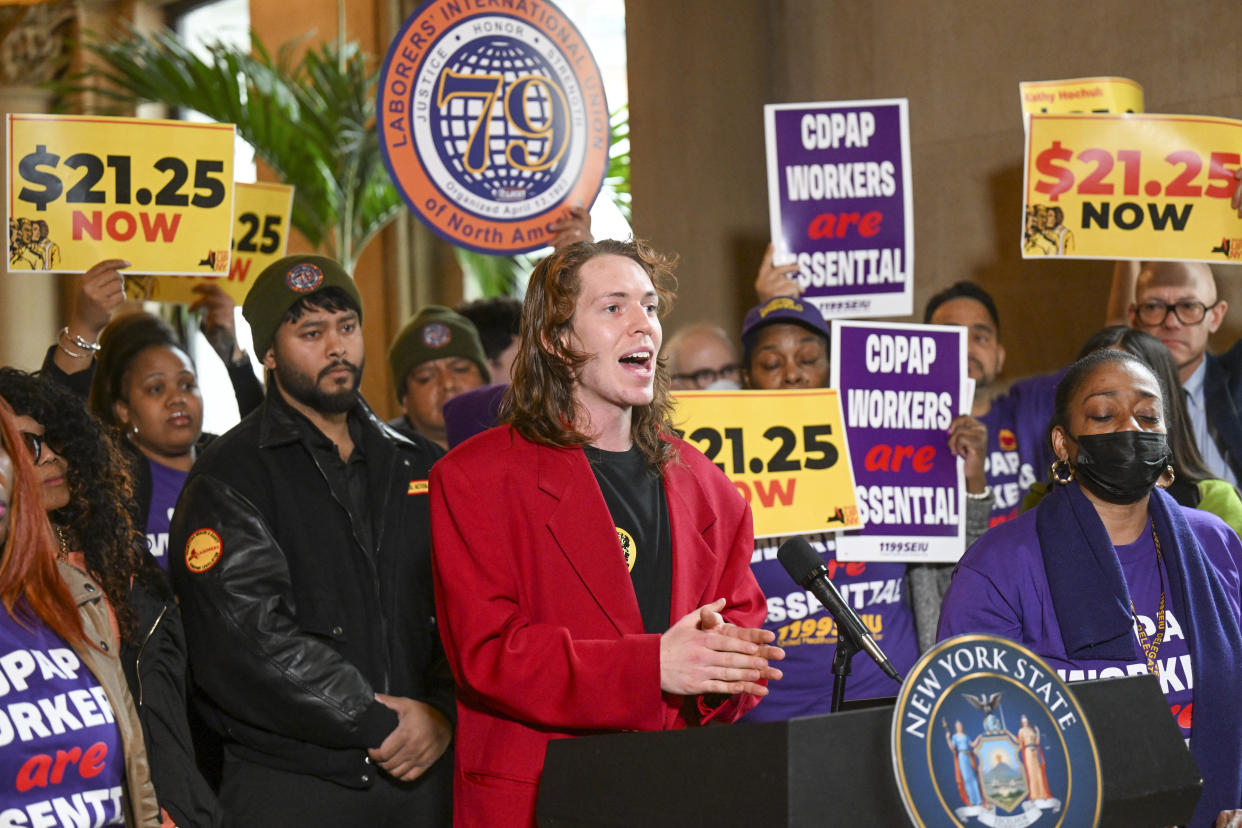 Tal Frieden, Campaign Coordinator for Raise UP NY, stands with protesters urging lawmakers to raise New York's minimum wage during a rally at the state Capitol, Monday, March 13, 2023, in Albany, N.Y. (AP Photo/Hans Pennink)