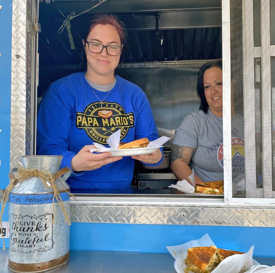 Tiffany Gernazio (right) and her daughter Michaella serve up "The Senior" grilled cheese sandwiches at the Papa Mario's food truck.