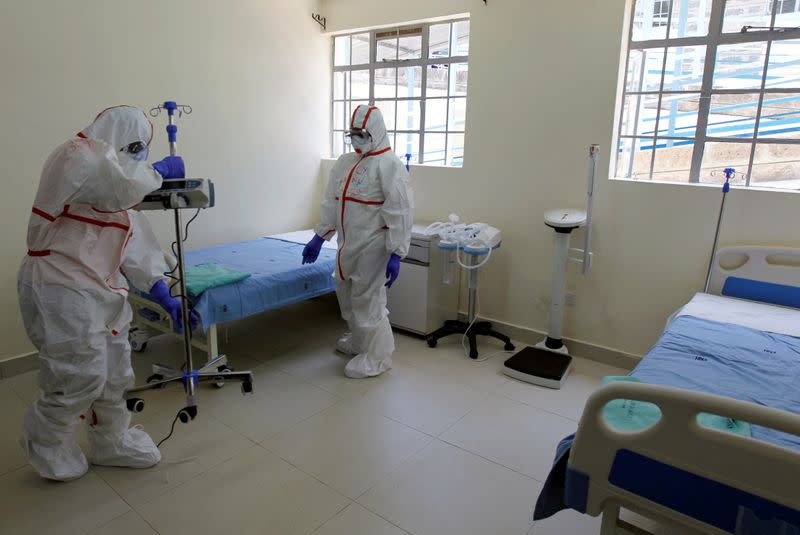 FILE PHOTO: Kenyan nurses wearing protective gear prepare a ward during a demonstration of preparations for any potential coronavirus cases at the Mbagathi Hospital, isolation centre for coronavirus, in Nairobi