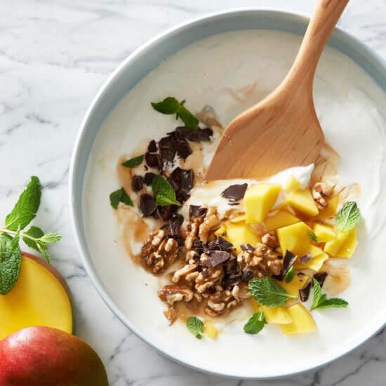 This homemade yogurt parfait gets a sweet and salty touch from mango, chocolate, and walnuts. Freshen up the mango yogurt bowl with a couple mint leaves.