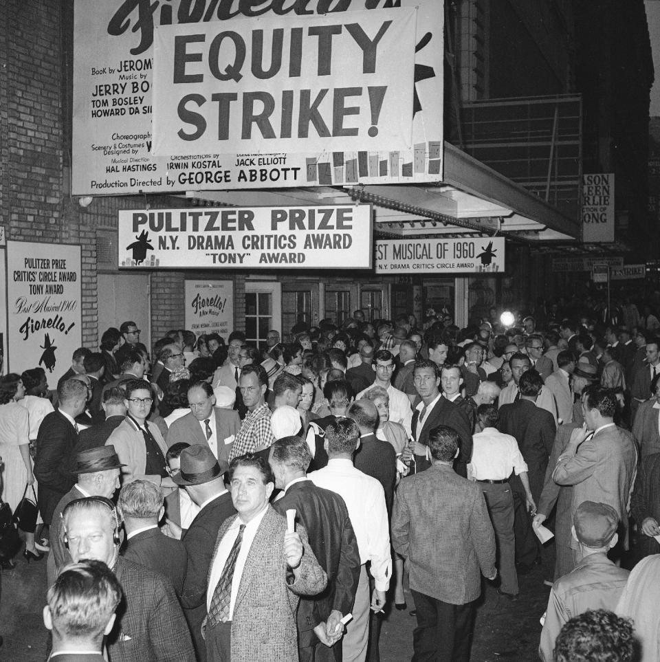 FILE - This June 2, 1960 file photo shows members of the cast and spectators crowding around the entrance to the New York's Broadhurst Theater on 44th Street. Producers of 22 Broadway shows shut down their productions in retaliation for actors walkout of a single show the night before. Actors' Equity contract expired at midnight on May 31 without a settlement of dispute with producers. The Actors' Equity Association, which has begun a yearlong celebration of its centennial, will get a Special Tony in recognition of their work negotiating wages, working conditions and benefits for stage performers and crew members. (AP Photo/Matty Zimmerman, file)