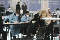 An elderly Jewish person arrives at a vaccination center to receive the Pfizer/BioNTech vaccine against the COVID-19 disease on International Holocaust Remembrance Day in Vienna, Austria, Wednesday, Jan. 27, 2021. Hundreds of Holocaust survivors in Austria and Slovakia were poised to get their first coronavirus vaccinations on Wednesday to acknowledge their past suffering with a special tribute 76 years after the liberation of the Auschwitz death camp, where the Nazis killed more than 1 million Jews and others. The vaccinations were also offered to all other Jews in the area older than 85. (AP Photo/Ronald Zak)