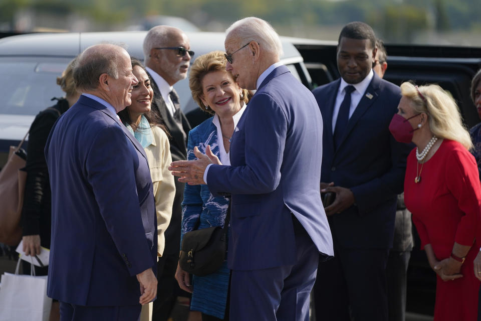 President Joe Biden speaks with Sen. Debbie Stabenow, D-Mich., Detroit Mayor Mike Duggan, left, and wife Sonia Hassan as he arrives at Detroit Metropolitan Airport, Wednesday, Sept. 14, 2022, in Detroit. Rep. Debbie Dingell, D-Mich., right, stands with Environmental Protection Agency Administrator Michael Regan. (AP Photo/Evan Vucci)