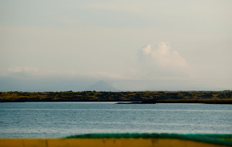 View from Reykjavik, with smoke on the horizon, towards the area where a volcano eruption was taking place, in Iceland