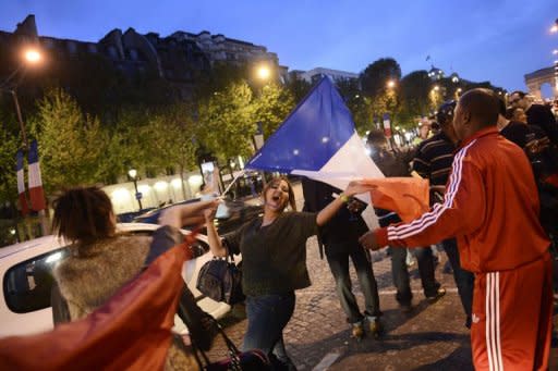 Supporters of Socialist Party (PS) newly elected French president Francois Hollande celebrate in the Champs Elysees in Paris. France's new president-elect won a quick early victory Sunday when other European leaders fell in behind his plan to build a new common growth strategy as soon as his rival's defeat was confirmed