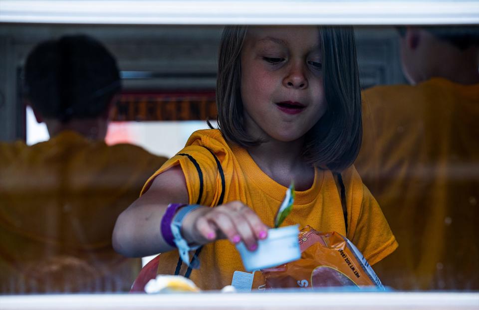 A child ate her lunch in a JCPS Bus Stop Cafe on Monday morning after a press conference to announce the continuation of the JCPS summer meals program for kids. June 6, 2022