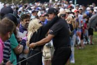 Phil Mickelson hugs his wife, Amy Mickelson, on the seventh fairway during the second round of the U.S. Open Golf Championship, Friday, June 18, 2021, at Torrey Pines Golf Course in San Diego. (AP Photo/Marcio Jose Sanchez)