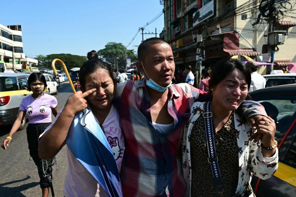 Relatives celebrate with a released prisoner outside Insein prison on Myanmar's Independence Day in Yangon (AFP via Getty Images)