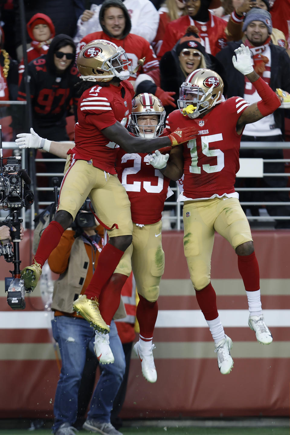 San Francisco 49ers running back Christian McCaffrey, middle, celebrates with Brandon Aiyuk, left, and wide receiver Jauan Jennings (15) after scoring a touchdown during the second half of an NFL football game against the Tampa Bay Buccaneers in Santa Clara, Calif., Sunday, Dec. 11, 2022. (AP Photo/Jed Jacobsohn)