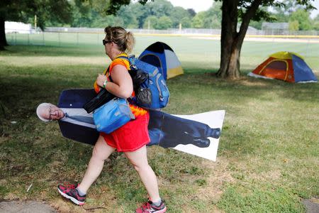 A woman carries a cutout of Bernie Sanders past tents in Franklin D. Roosevelt park on the first day of the Democratic National Convention in Philadelphia. REUTERS/Dominick Reuter