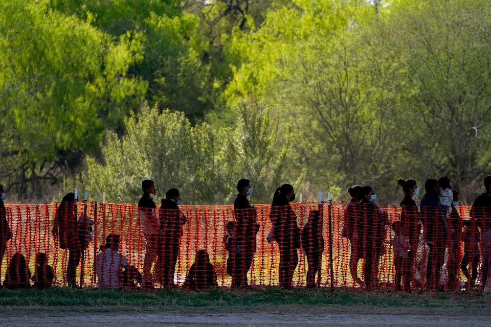 Migrants are seen in custody at a U.S. Customs and Border Protection processing area under the Anzalduas International Bridge, Friday, March 19, 2021, in Mission, Texas. An increasing number of migrants on the Southwest border has the Biden administration on the defensive. The head of Homeland Security acknowledged the severity of the problem Tuesday but insisted it's under control and said he won't revive a Trump-era practice of immediately expelling teens and children. An official says U.S. authorities encountered nearly double the number children traveling alone across the Mexican border in one day this week than on an average day last month. (AP Photo/Julio Cortez)