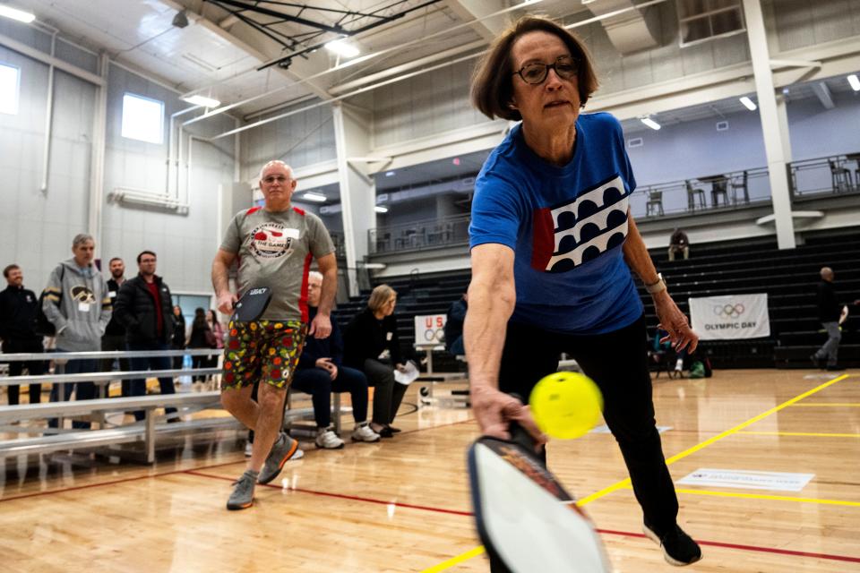 Des Moines Mayor Connie Boesen reaches to hit a whiffle ball while practicing pickleball during Senior Games Community Day at MidAmerican Energy Company RecPlex in West Des Moines.