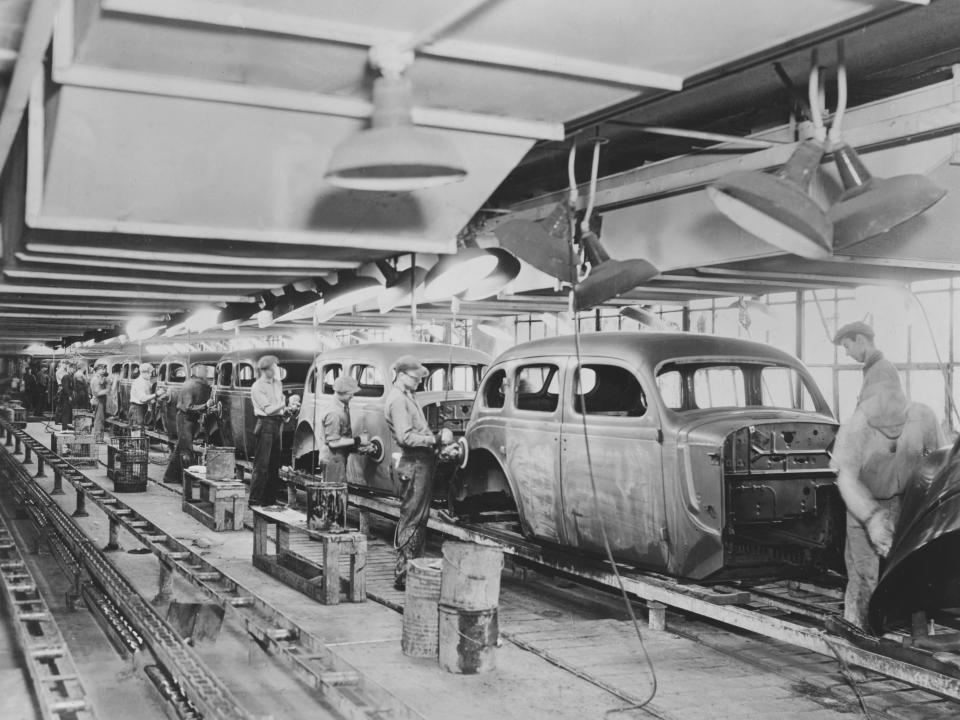 Workers on a motor car production line at a factory, USA, circa 1930.