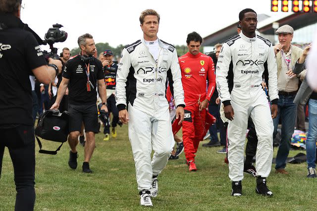 <p>Ryan Pierse/Getty Images</p> Pitt and Idris wore white and black racing suits for fictional team APXGP