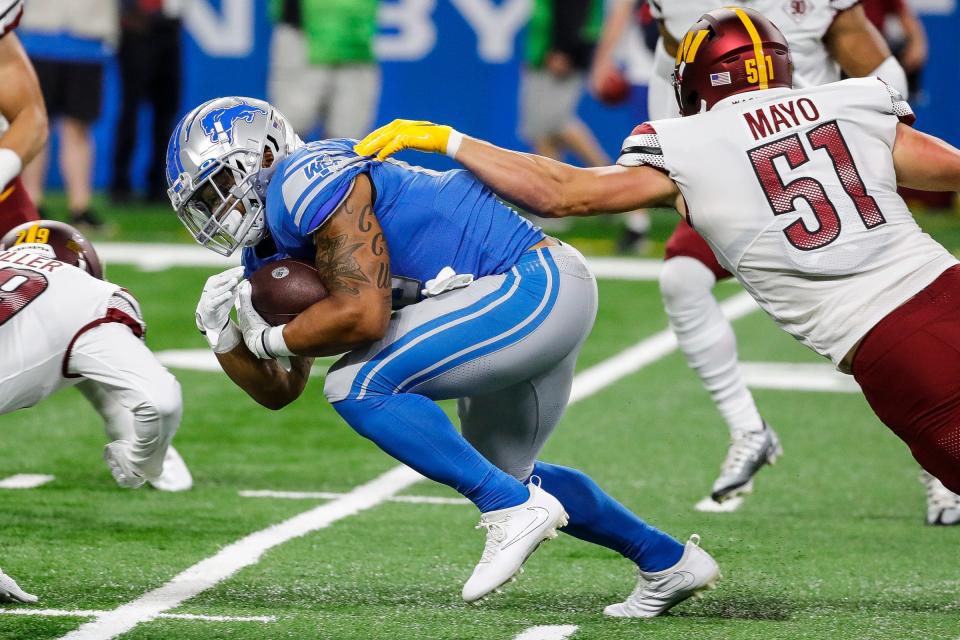 Detroit Lions running back Craig Reynolds (46) runs against Washington Commanders linebacker David Mayo (51) during the first half at Ford Field, Sept. 18, 2022.