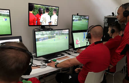 Video Assistant Referees (VAR) watch a practice match as they train in the use of the technology, during a seminar for match officials organised by FIFA ahead of the World Cup in Florence, Italy April 19, 2018. REUTERS/Brian Homewood