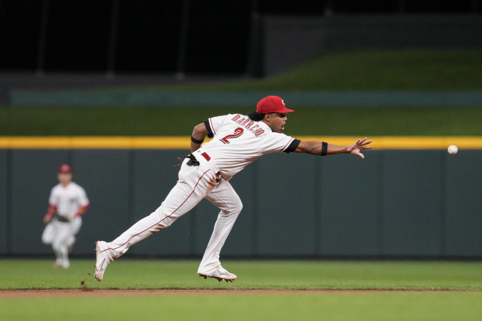 Cincinnati Reds shortstop Jose Barrero (2) throws to second baseman Spencer Steer to begin a double-play off a ground ball hit by Chicago Cubs' Christopher Morel during the eighth inning of a baseball game Monday, Oct. 3, 2022, in Cincinnati. (AP Photo/Jeff Dean)