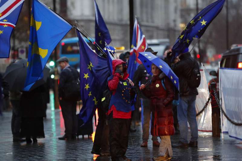 倫敦街頭仍有民眾揮舞著歐盟旗幟，希望英國能夠繼續留在歐盟。（美聯社）