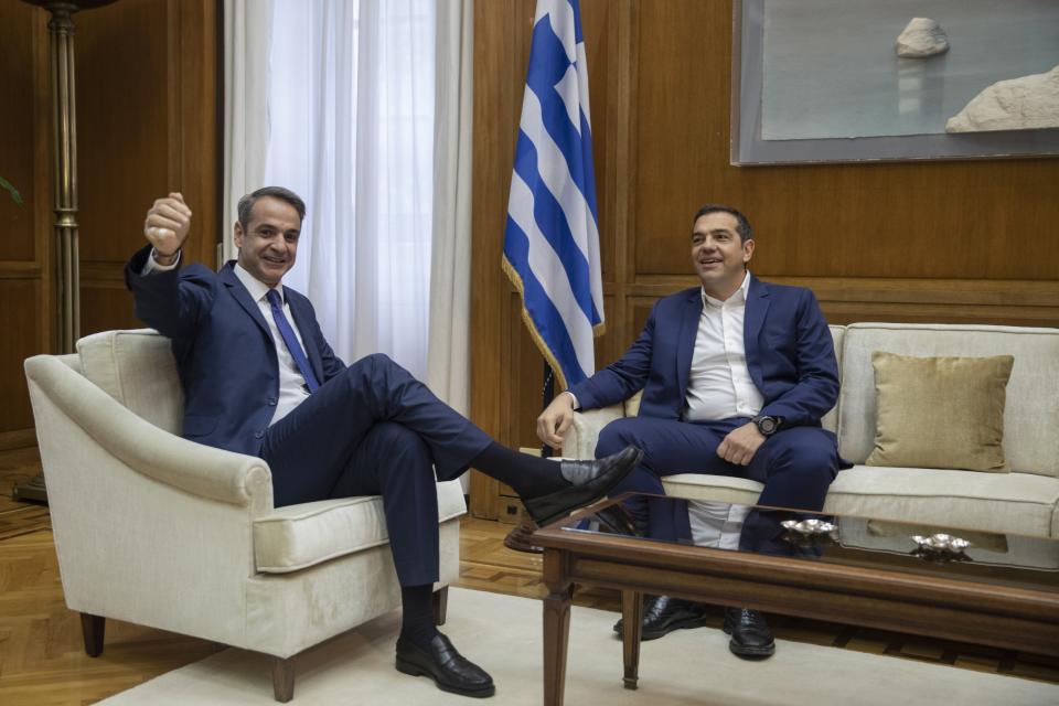 FILE - IGreek Prime Minister Kyriakos Mitsotakis, left, gestures during his meeting with Syriza party leader Alexis Tsipras, in Athens, Greece, Friday, Oct. 11, 2019. Greece's left-wing opposition leader, Alexis Tsipras has announced his decision to step down after a crushing election defeat. Tsipras made the announcement on Thursday, June 29, 2023. The 48 year-old politician served as Greece's prime minister from 2015 to 2019 during politically tumultuous years as the country struggled to remain in the euro zone and end a series of international bailouts. (AP Photo/Petros Giannakouris, File)