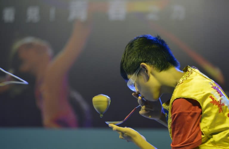 A student demonstrates teetotum skills to celebrate the Summer Universiade in Taipei