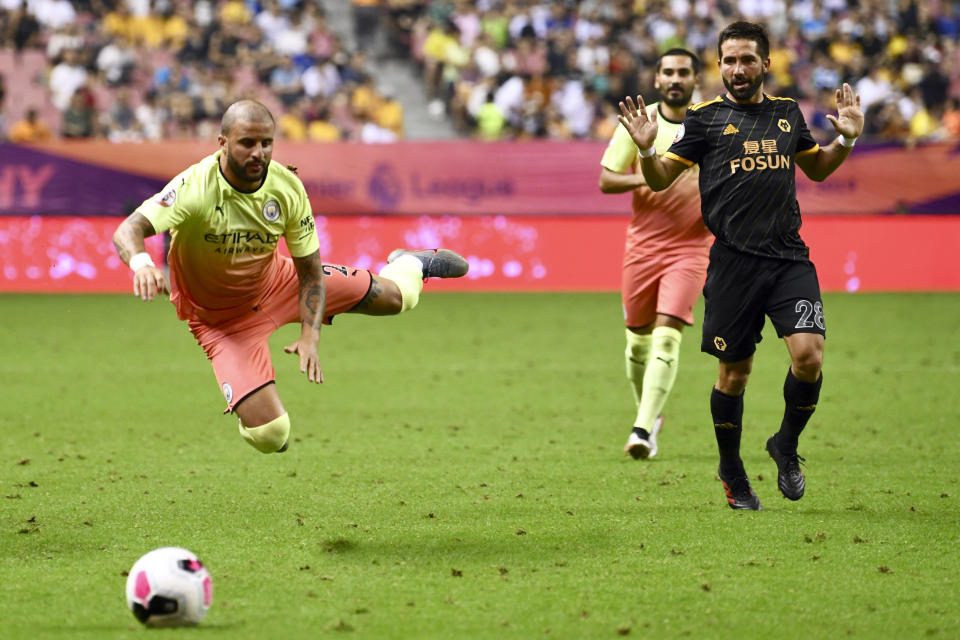 Manchester City's David Silva leaps for the ball in the final of the Premier League Asia Trophy in Shanghai, China, Saturday, July 20, 2019. Wolverhampton Wanderers beat Manchester City in the final by 3-2 in the penalty shoot-out. (Chinatopix Via AP) CHINA OUT