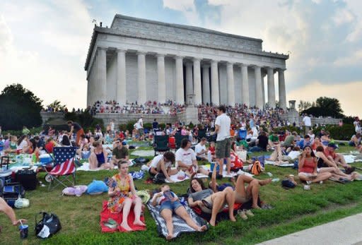 People gather at the Lincoln Memorial to watch fireworks in celebration of Fourth of July in Washington, DC, on July 4, 2012. Independence Day, commonly known as the Fourth of July, is a federal holiday in US commemorating the adoption of the Declaration of Independence on July 4, 1776, declaring independence from Great Britain