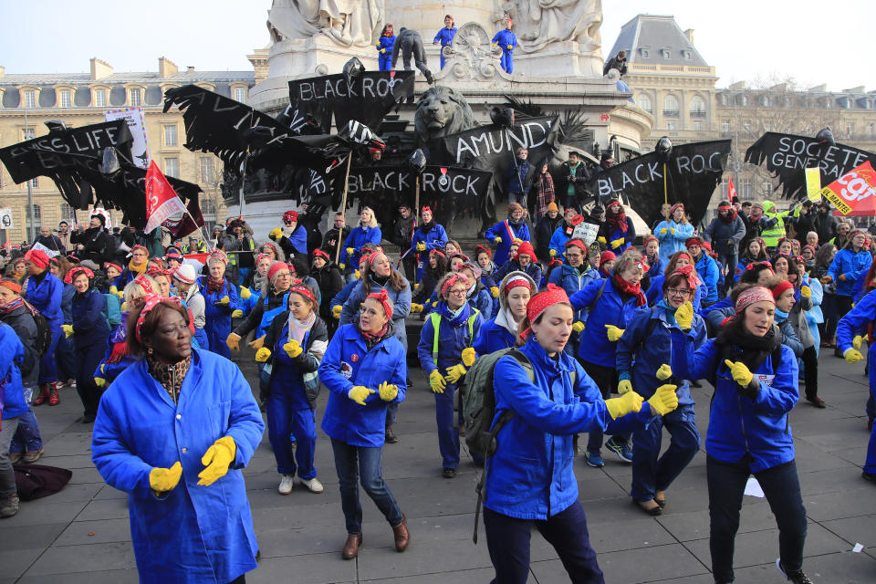 Women perform a dance against French President Emmanuel Macron during a demonstration, Friday, Jan. 24, 2020 in Paris. French unions are holding last-ditch strikes and protests around the country Friday as the government unveils a divisive bill redesigning the national retirement system. (AP Photo/Michel Euler)