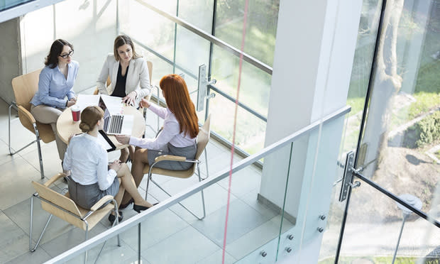 Businesswomen working at table