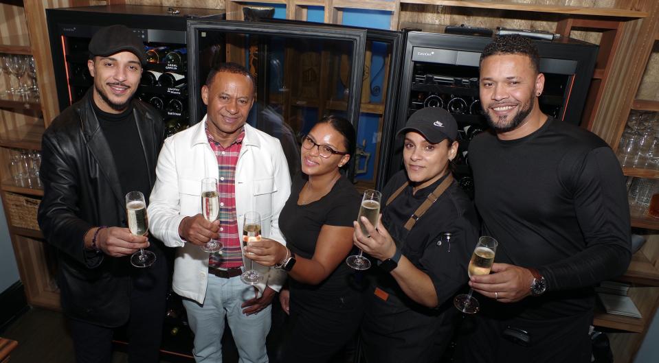 The team that makes it happen at Brockton Café Bar & Grill, manager Shane Perkins, owner Domingos Veiga, bartender Luisa Lopes, head chef Margarita Ramos and server Ailton Delgado, raise champagne-filled glasses to the ongoing success of the restaurant on Wednesday, Dec. 27, 2023.