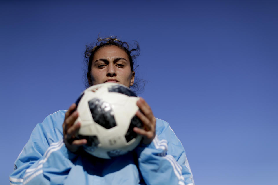 In this Nov. 1, 2018 photo, Argentina national female soccer player Luana Munoz poses for a photo at the Argentina Football Association, after a training session in Buenos Aires, Argentina. "Women are not accepted in this environment yet. That's why there's so much resistance to broadcasting female sports, especially soccer," said 19-year-old wingback. (AP Photo/Natacha Pisarenko)