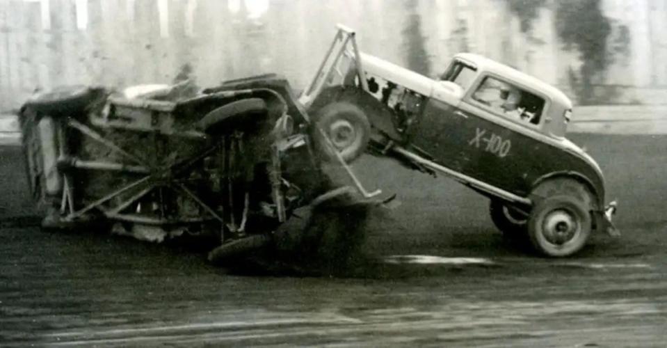 A car rolls and the X-100 passes over the car and continues on with the race at Barberton Speedway in 1951.