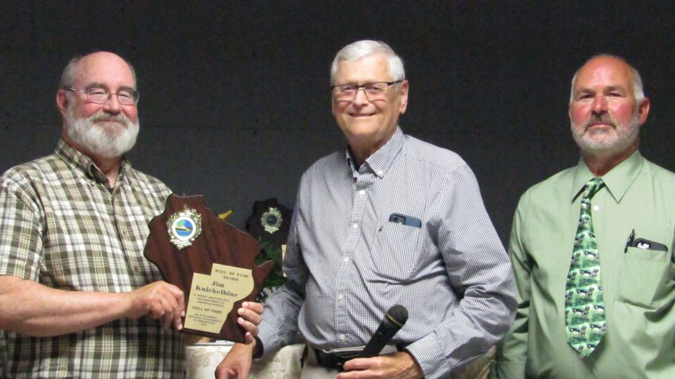 Jim Knickelbine (from left) of Woodland Dunes, enshrinee, with Tom Kocourek representing Northeastern Wisconsin Great Lakes Sport Fishermen and Larry Bonde, Hall of Fame emcee.
