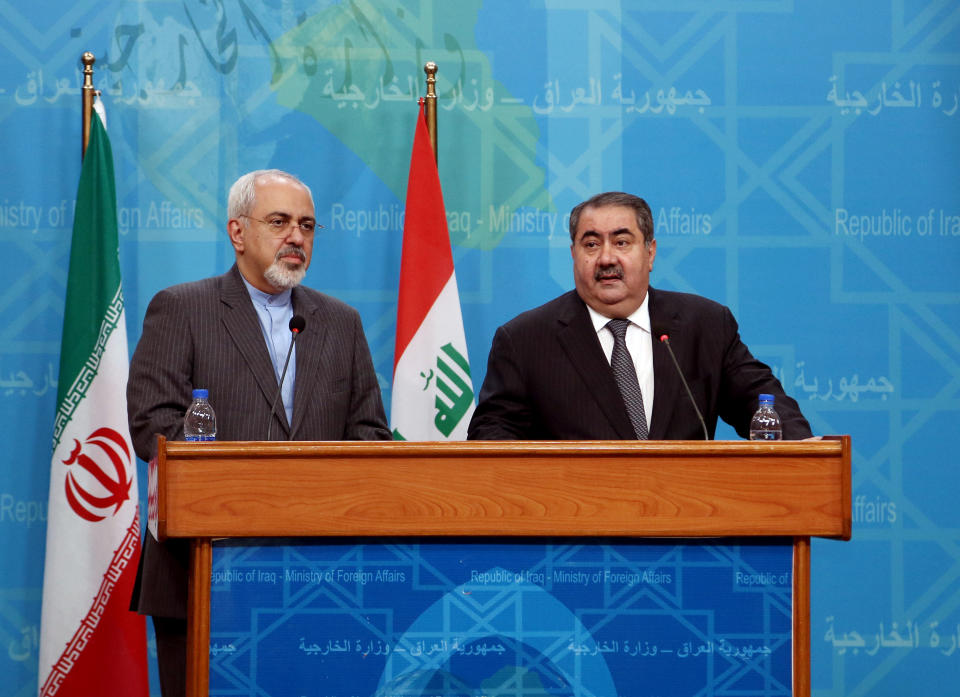 Iraqi Foreign Minister Hoshyar Zebari, right, speaks to the media during a joint press conference with his Iranian counterpart Mohammad Javed Zarif in Baghdad, Iraq, Tuesday, Jan. 14, 2014. (AP Photo/Khalid Mohammed)